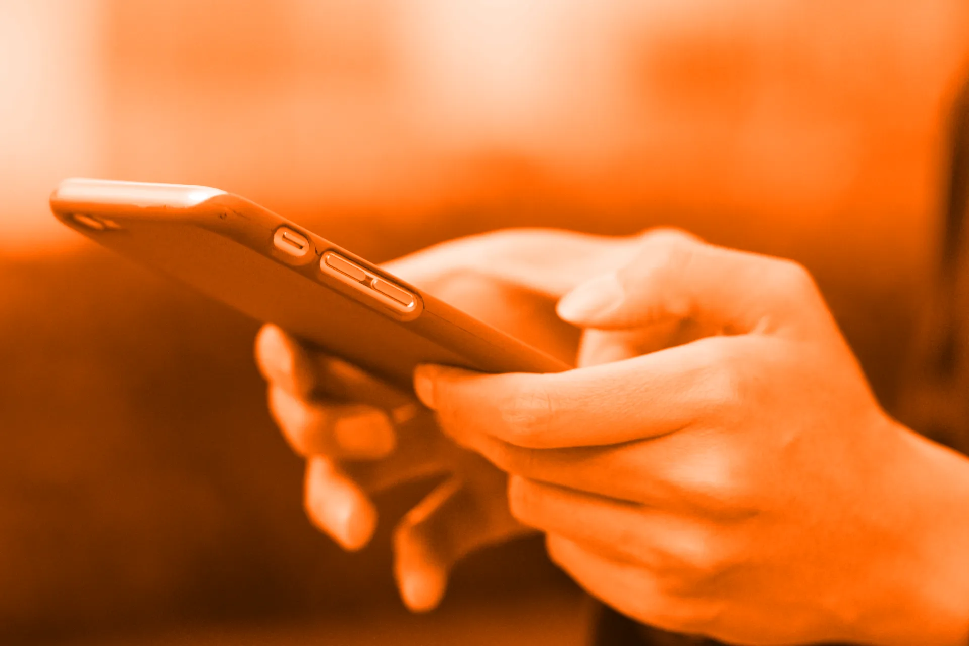 Mobile phone user checking their social media advertising performance