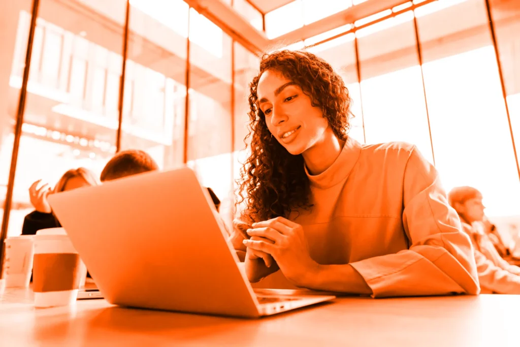 Young woman using a laptop to update her website